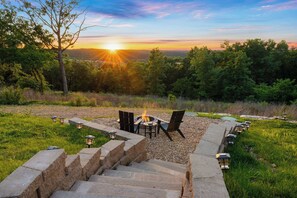 End your day by the fire, surrounded by nature and breathtaking sunset views.