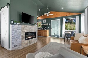 Cozy up by the modern fireplace in this stylish, sunlit retreat.