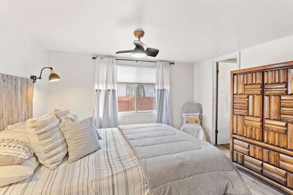 Primary bedroom boasts a queen-sized bed with armoire.