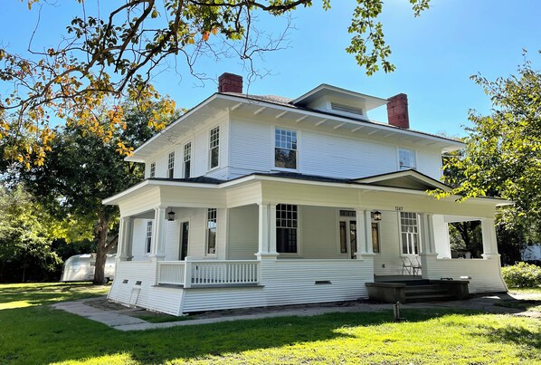 Fully restored 1912 Craftsman home.  Behind, a 1956 Airstream writer's studio. 