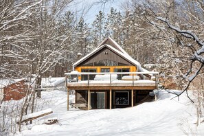 Welcome to your charming Up North cabin, nestled in the woods along the serene Betsie River.