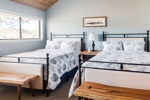 Upstairs bedroom with two queen beds, 45 inch Smart Roku TV, and walk-in closet