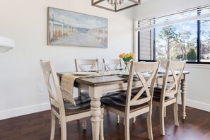 Dining area with full dinnerware sets and glassware