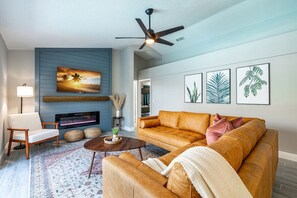 Relax in the cozy living room with a fireplace and stylish, inviting decor.