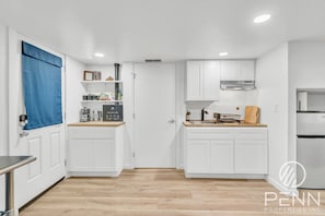 Wake up and start your day with coffee in this bright, simple kitchenette space made for easy mornings.
