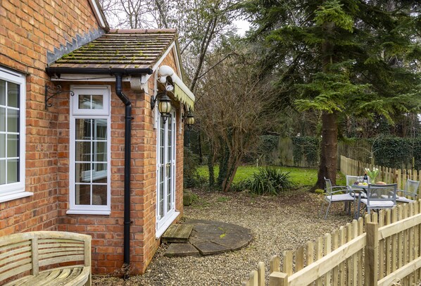The patio leads round to the enclosed lawned garden