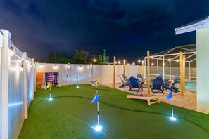 Putt-putt, giant cornhole, and Jenga—fun for the whole family in our backyard paradise! 