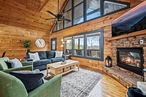  Enjoy the warmth of the fireplace and stunning views through the large windows.