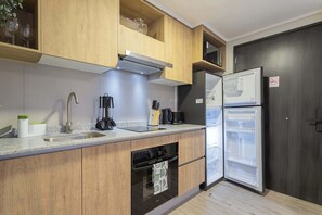 Experience a modern kitchen with sleek cabinetry and essential appliances, perfect for preparing meals during your stay.