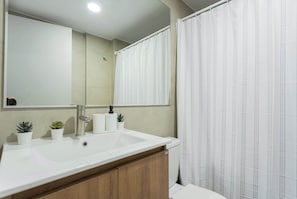 Relax in this modern bathroom featuring a sleek sink and stylish decor, perfect for unwinding after a day of adventure.