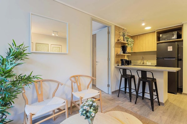 Experience comfort in this stylish living area with a kitchenette, perfect for relaxing after a day of adventure!