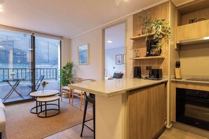Experience modern comfort in this stylish living area with a cozy balcony, perfect for unwinding after a day of adventure!