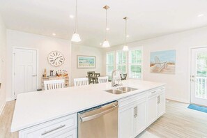 second level spacious kitchen opens door to Patio with Tree line Views.