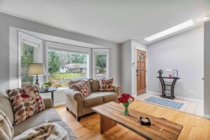 The living room is a wonderful conversation place with comfortable seating and an open floorplan into the dining room. Sit back, relax, read a book or enjoy the beautiful neighborhood views. 