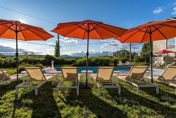 Lounge seating by the pool with mountain views