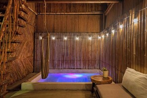 Beautiful plunge pool surrounded by comfortable furniture, and a fantastic hammock