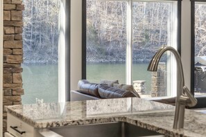 The airy, open kitchen offers ample space & every home comfort