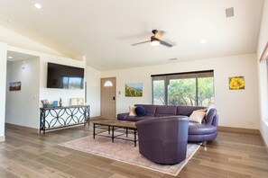 Living area with leather couches and smart TV