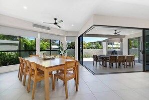 Host memorable meals at the timber table for ten, where garden views and the open-plan design enhance every gathering.