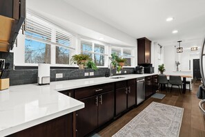 The kitchen features spacious counters, offering plenty of room for meal preparation and cooking.
