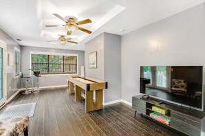 The game room opens directly to the backyard, creating the perfect blend of entertainment and fresh air.