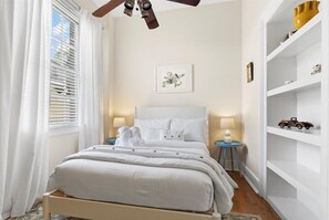 The second bedroom at Jones Artist Boutique is filled with natural light, offering a serene retreat with charming details and a comfortable stay.