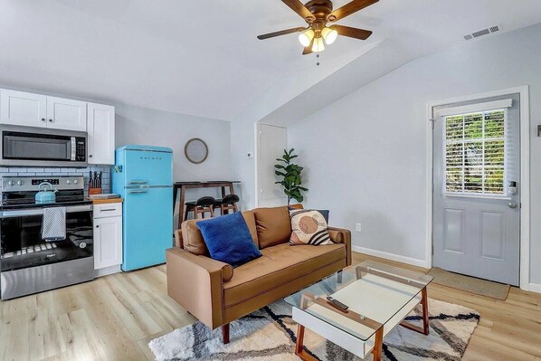 Cozy up in the living room, where natural light meets modern comfort—complete with a smart TV for your favorite shows and movies!