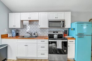 Whip up something special in this charming kitchenette—small in size but big on character and fully equipped for your culinary needs!