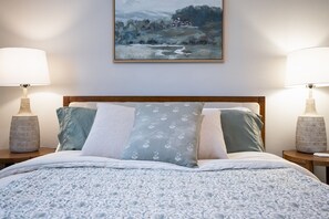 The second bedroom features a plush queen bed and a smart TV, creating the perfect space to relax and recharge.