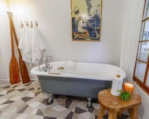 Unwind in the elegance of this clawfoot tub, the perfect place to relax after a day of exploring Savannah.