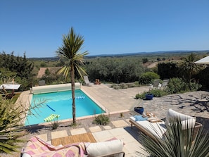 Terrace with far reaching views over the plain - sitting area, loungers and hammock.