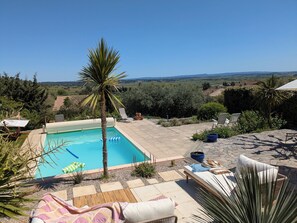 Terrace with far reaching views over the plain - sitting area, loungers and hammock.