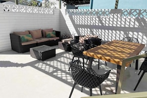 Private walled patio with alfresco dining , BBQ and comfy couch.