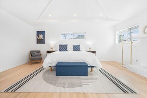 Huge primary suite with parents retreat , private ensuite, fireplace,workspace with desk.
Doors open onto the patio with comfy couches and seating area.