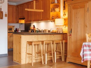 Furniture, Wood, Kitchen, Flooring, Interior Design, Countertop, Cabinetry, Wood Stain, Floor, Hardwood