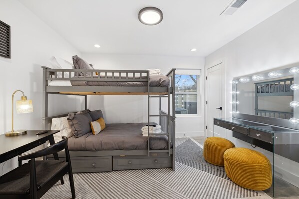 Bedroom 2: A cozy bedroom with a bunk bed, workspace, and glam vanity for added comfort and style.