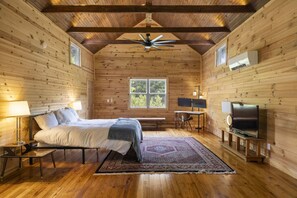 The third floor bedroom features vaulted ceilings with uplighting and a beautiful  view of the river.