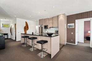 The gourmet kitchen flows into the living room, dining room and out onto the large deck