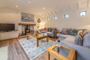 Greyseals, Brancaster: Sitting room with wood burning stove