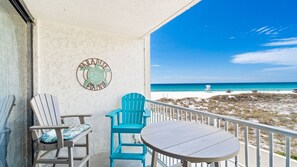 This private beachfront balcony offers the perfect spot to relax with a drink and soak in panoramic views of sugar-white sand and emerald waters. With comfortable seating and a coastal "Paradise Found" vibe, it’s an ideal place to unwind and enjoy the oce