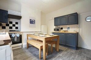 Clean Navy Kitchen with Dining Facilities 
