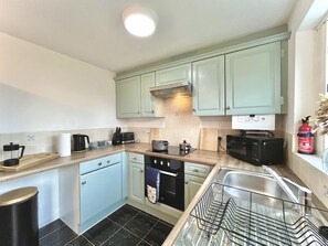 Enjoy preparing homey meals in our charming kitchen 