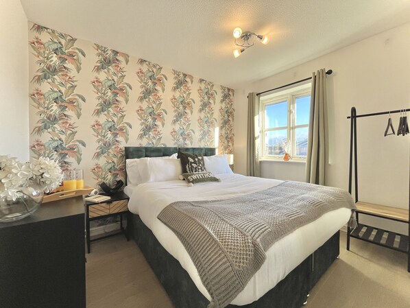 Spacious double bedroom with modern decor, natural light, and nice ambiance