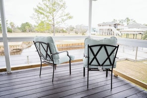 Waterfront escape with a cozy porch, perfect for enjoying peaceful views and morning coffee. Relax and unwind in this serene getaway!