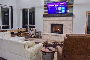 Propane fireplace in the living room w/ a smart tv.