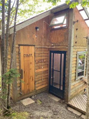 Shared washrooms with a hot shower, composting toilet, and multiple sinks 