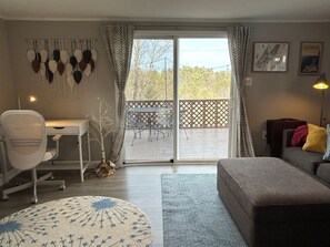 The cozy living room opens onto the patio, with a sweeping view of the hills.