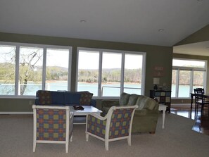 first floor grand living room with floor to ceiling windows of lakefront