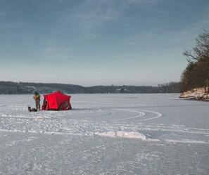 Ice fishing directly in front of the cabin.