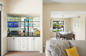 Chic wine glass corner with glassware display and elegant storage cabinet.